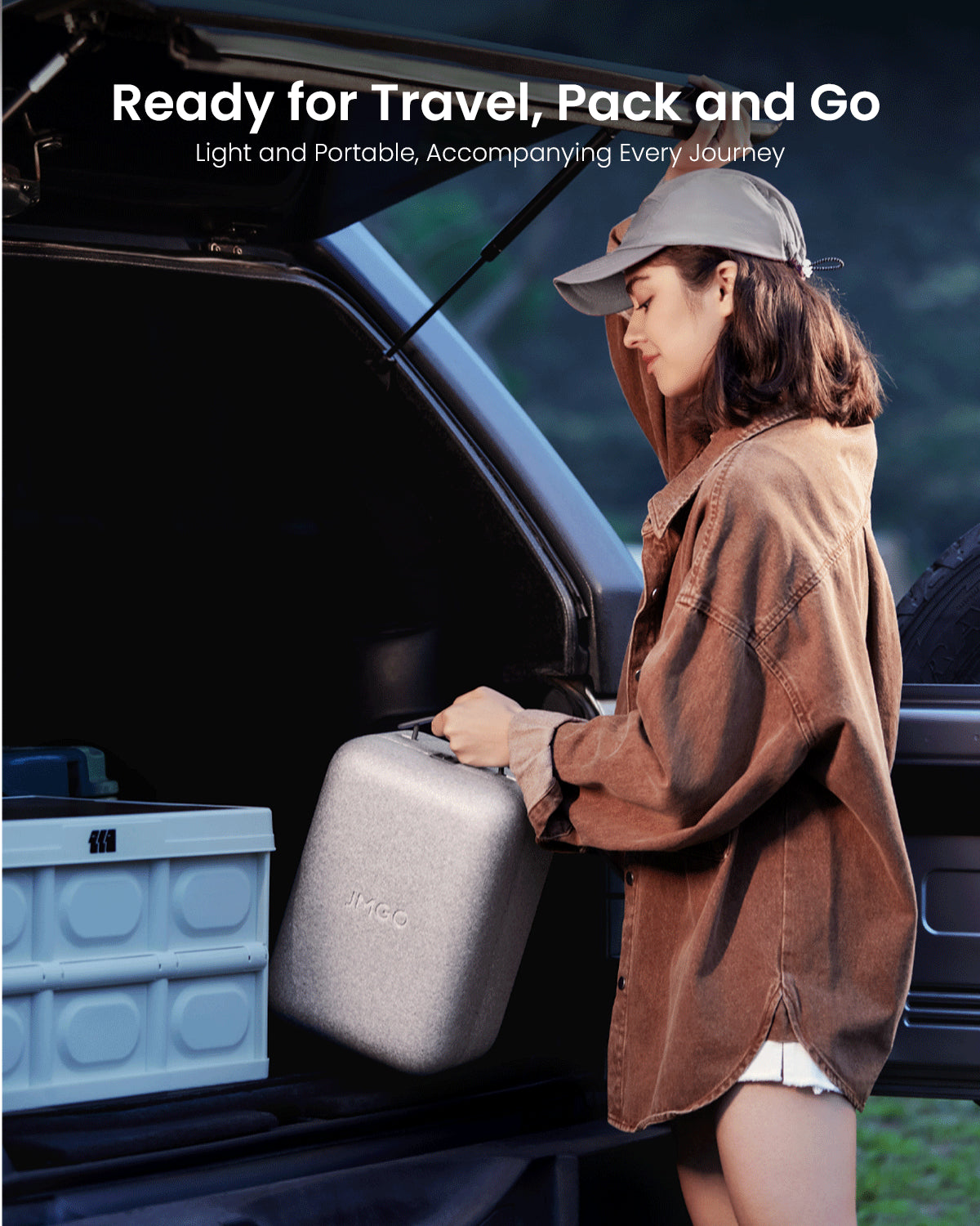 A woman preparing to take the lightweight JMGO N1S portable home theater projector on a trip, easy to carry and perfect for outdoor entertainment, movies, and streaming on the go